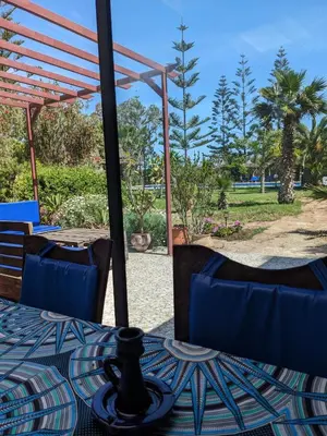 a table and chairs with a view of a park at Mesdunes in Azemmour