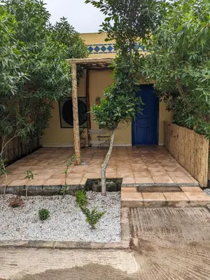 a house with a blue door and a tree at Mesdunes in Azemmour