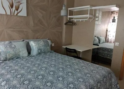 a bedroom with a bed and a desk and a room with a bed sidx sidx at Aryam Room in Rabat