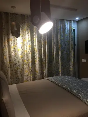 a bedroom with a bed with a curtain and a light at Aryam Room in Rabat