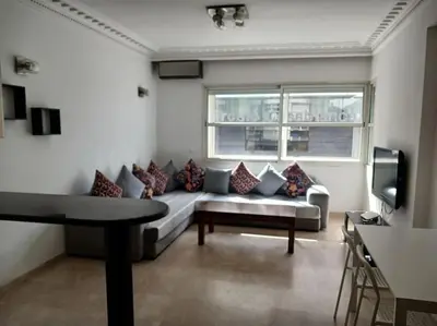 a living room with a couch and a window at Gauthier confort in Casablanca