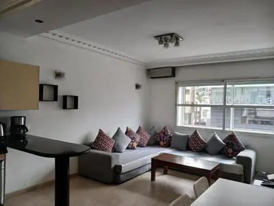 a living room with a couch and a table at Gauthier confort in Casablanca