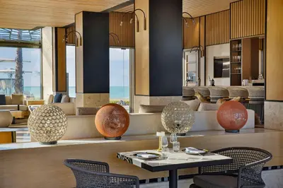 a dining room with a table and chairs at Conrad Rabat Arzana in Rabat