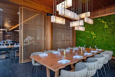 a dining room with a long table and chairs at Conrad Rabat Arzana in Rabat