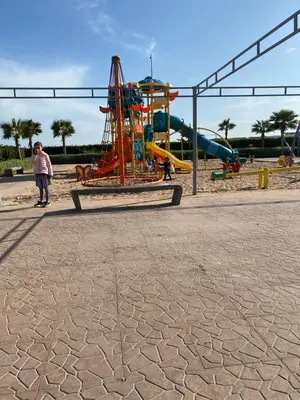 a park with a playground with a roller coaster at Appartement blanca beach Sidi Rahal accès direct à la plage in Casablanca