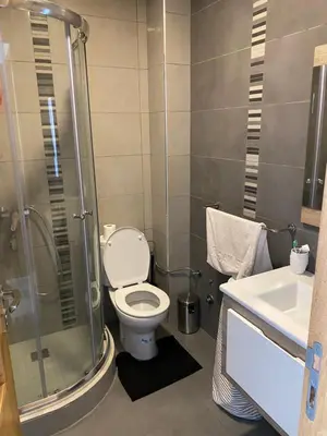 a bathroom with a shower and a toilet and a sink at Appartement blanca beach Sidi Rahal accès direct à la plage in Casablanca