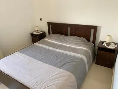a bedroom with a large bed with two night stands at Appartement blanca beach Sidi Rahal accès direct à la plage in Casablanca