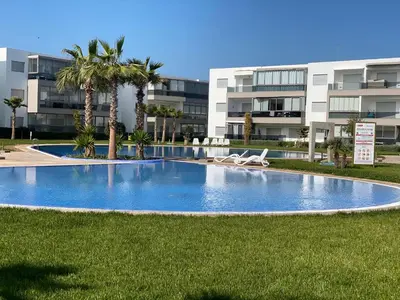 an empty swimming pool in front of a building at Appartement blanca beach Sidi Rahal accès direct à la plage in Casablanca