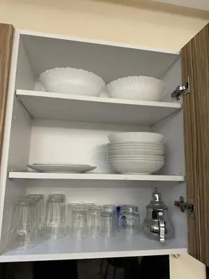a cabinet filled with plates and bowls and glasses at Central Park House - 70m² in Mohammedia