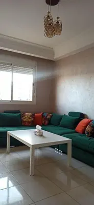a living room with a green couch and a coffee table at La Perle in Casablanca