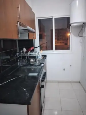 a kitchen with a black counter top and a window at La Perle in Casablanca