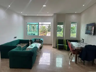 a living room with a couch and tables and windows at 2mars in Casablanca