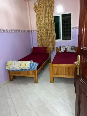 two beds in a room with a window at 2mars in Casablanca