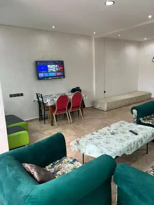 a living room with couches and a table and a tv at 2mars in Casablanca
