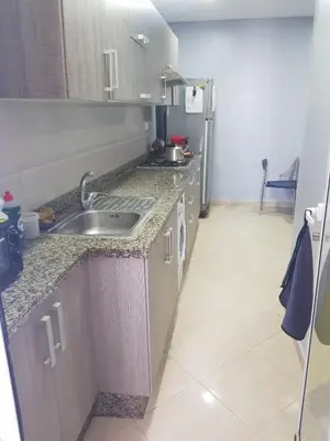 a kitchen with a sink and a counter top at Beach-Side 2-BR Oasis with Private Pool & Parking in Casablanca