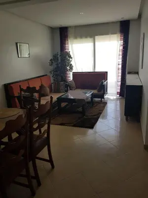 a living room with a couch and a table at Beach-Side 2-BR Oasis with Private Pool & Parking in Casablanca