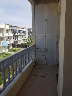 a glass table on a balcony with a door at Beach-Side 2-BR Oasis with Private Pool & Parking in Casablanca