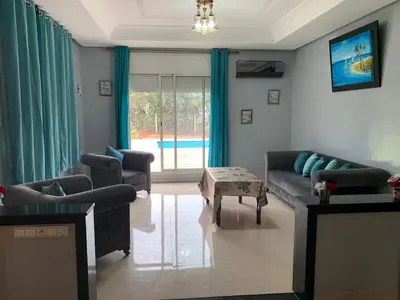 a living room with a couch and a table at American Farm Villa Grand Casablanca/El Jadida in Zaouia Sidi Bou Azza