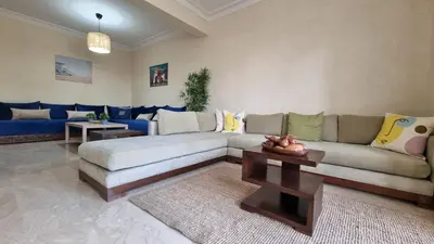 a living room with a couch and a table at My Cosy Place Rabat - Skhirat 2min de la plage avec Piscine in Skhirat