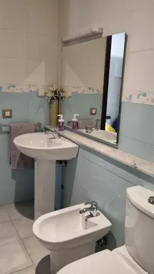 a bathroom with a sink and a toilet and a mirror at My Cosy Place Rabat - Skhirat 2min de la plage avec Piscine in Skhirat