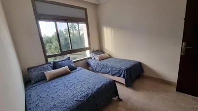 a bedroom with two beds and a window at My Cosy Place Rabat - Skhirat 2min de la plage avec Piscine in Skhirat