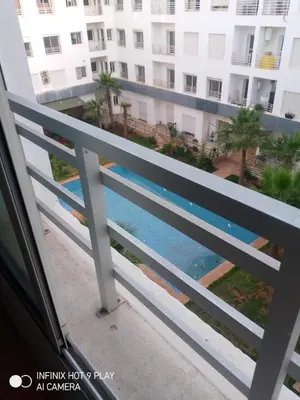 a view of the pool from the balcony of a apartment at Belfakih in Beni Brour