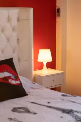 a bedroom with a bed and a lamp on a night stand at La cascade de Maryline in Casablanca