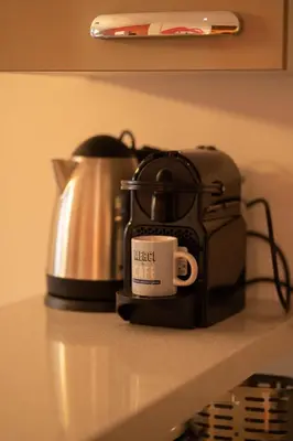 a toaster and a coffee cup sitting on a counter at La cascade de Maryline in Casablanca