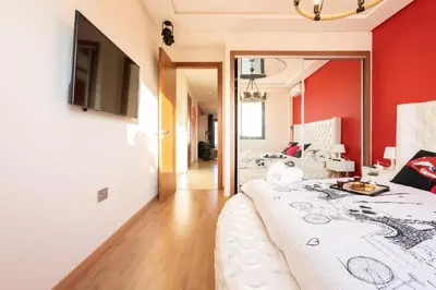 a bedroom with red walls and a white bed at La cascade de Maryline in Casablanca