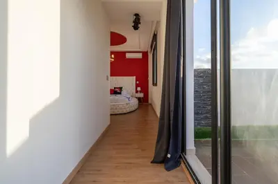 a hallway with sliding glass doors leading to a bedroom at La cascade de Maryline in Casablanca