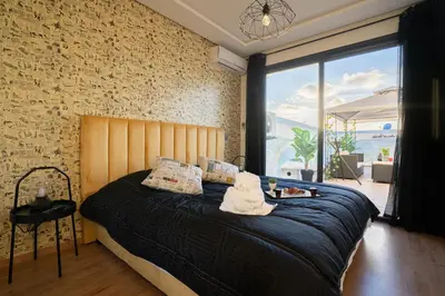 a bedroom with a large bed with a large window at Le Vintage Dead Sea in Casablanca