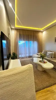 a large living room with a couch and a table at Studio et place parking gratuite in Casablanca