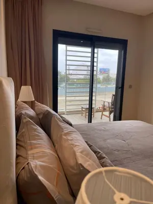 a bedroom with a bed with a view of the beach at Luxury Flat in Casa Finance City in Casablanca