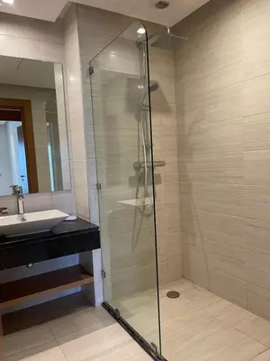 a glass shower in a bathroom with a sink at Luxury Flat in Casa Finance City in Casablanca