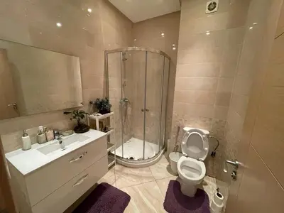 a bathroom with a shower and a toilet and a sink at The garden corner in Bouznika