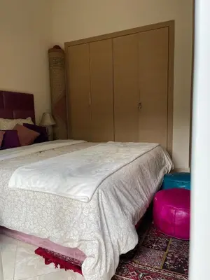 a bedroom with a bed and a large closet at The garden corner in Bouznika