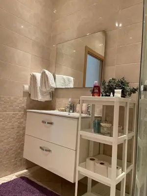 a bathroom with a sink and a mirror at The garden corner in Bouznika