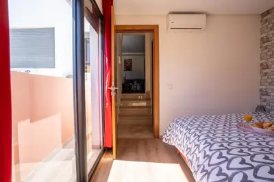 a bedroom with a bed and a door to a hallway at Terrasses de Marrakech- Au coeur de Casablanca in Casablanca