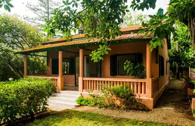 a house with a porch and stairs to it at Charmante Maison 2ch et Bungalow 2ch au Coeur de l'Oasis in Casablanca