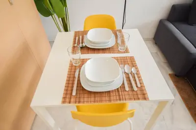 a dining table with plates and bowls on it at YourPlace - Prestigia - Hay Riad in Rabat