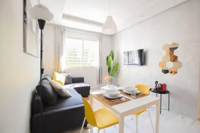a living room with a table and a couch at YourPlace - Prestigia - Hay Riad in Rabat