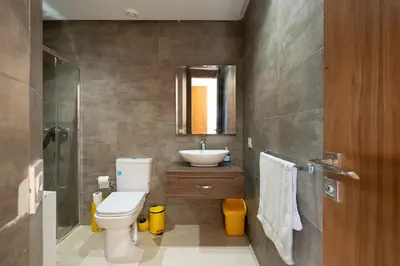 a bathroom with a white toilet and a sink at Jardin de Majorelle location journalière Casablanca in Casablanca