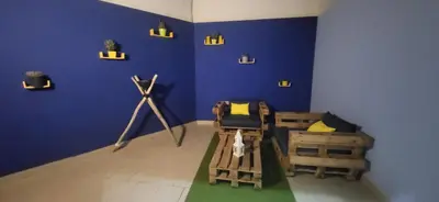 a room with a blue wall with two beds and a telescope at Jardin de Majorelle location journalière Casablanca in Casablanca
