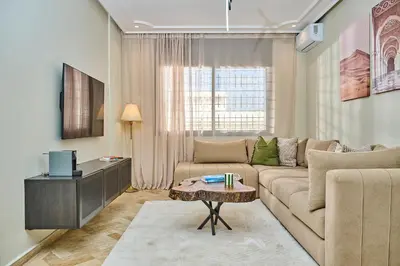 a living room with a couch and a tv at YourPlace Rabat Agdal 1 - Cozy Residence in Rabat