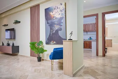 a living room with a large painting on the wall at YourPlace Rabat Agdal 1 - Cozy Residence in Rabat