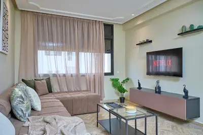 a living room with a couch and a tv at YourPlace Rabat Agdal 1 - Cozy Residence in Rabat