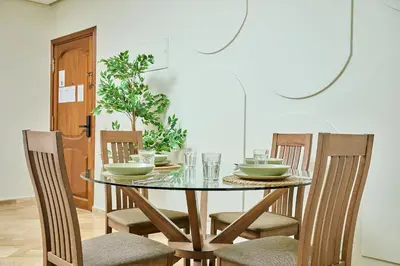 a dining room with a glass table and chairs at YourPlace Rabat Agdal 1 - Cozy Residence in Rabat