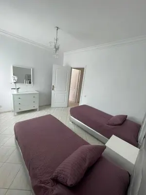 a bedroom with two beds and a sink at Appartement standing spacieux Casablanca in Casablanca