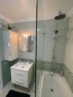 a bathroom with a shower and a sink and a tub at Appartement standing spacieux Casablanca in Casablanca