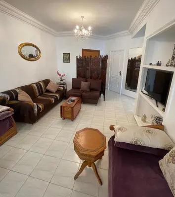 a living room with two couches and a tv at Appartement standing spacieux Casablanca in Casablanca